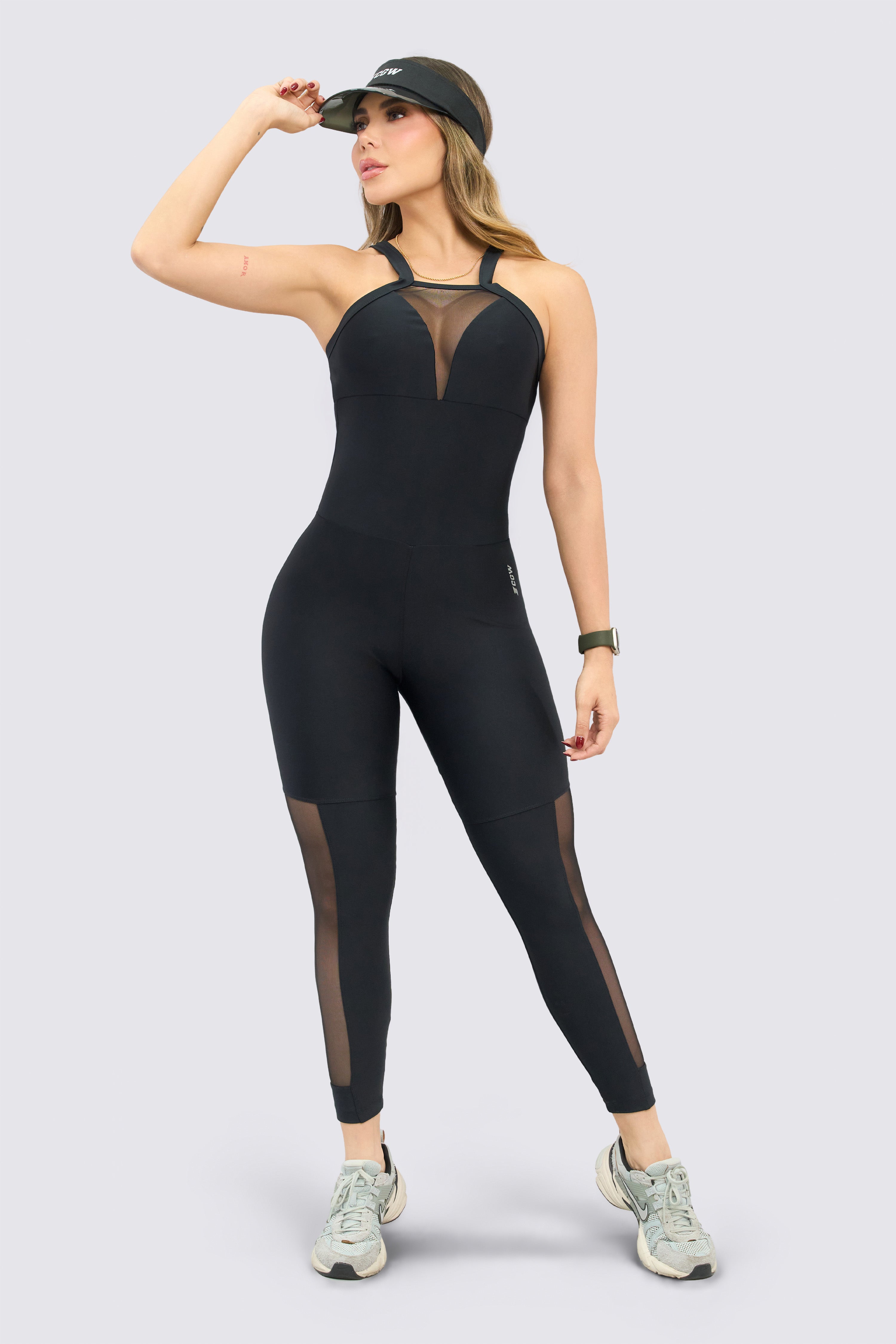 Black sports jumpsuit with embedded mesh panels that aid ventilation during exercise.