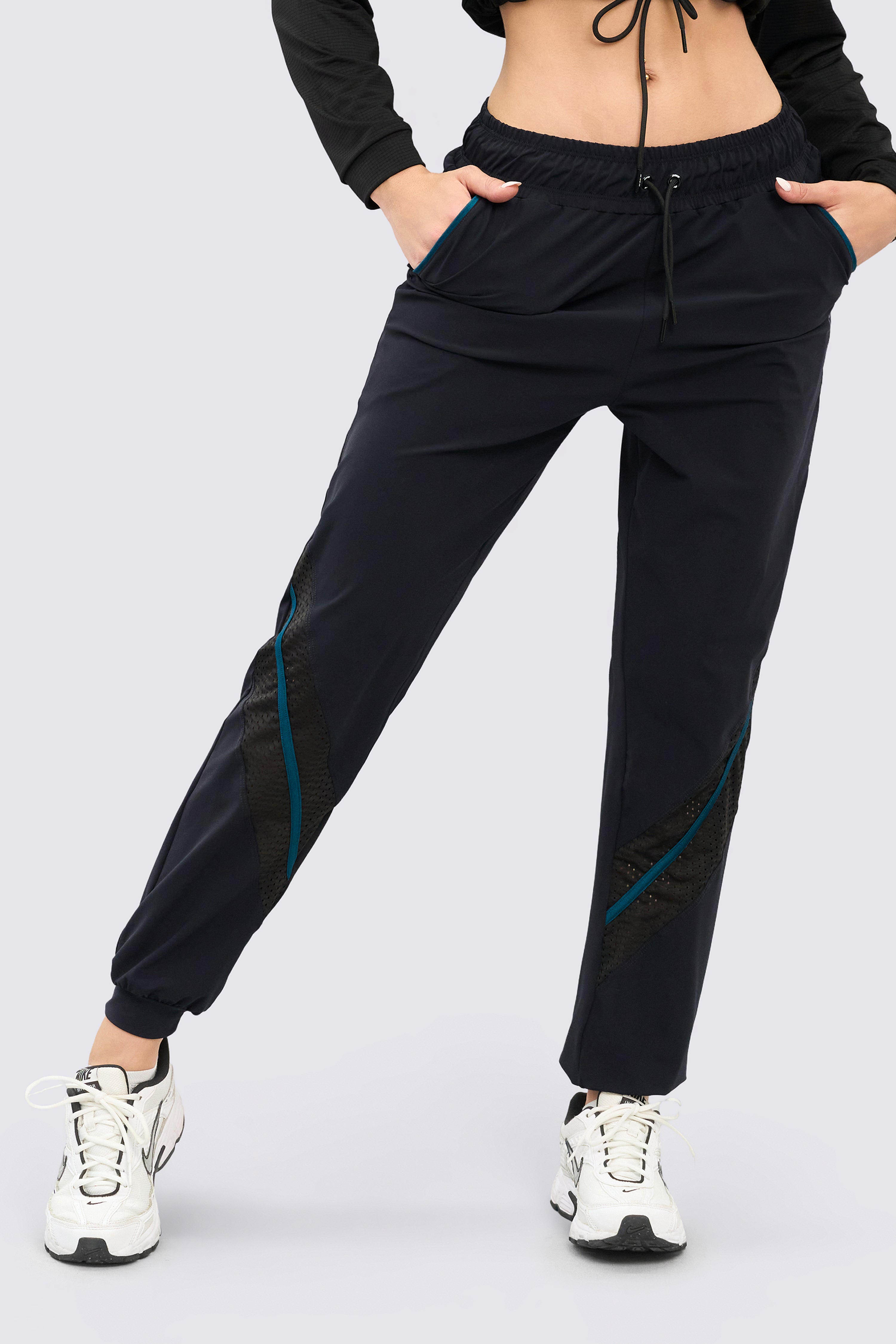 Black athletic joggers with functional pockets and an adjustable elastic waistband.
