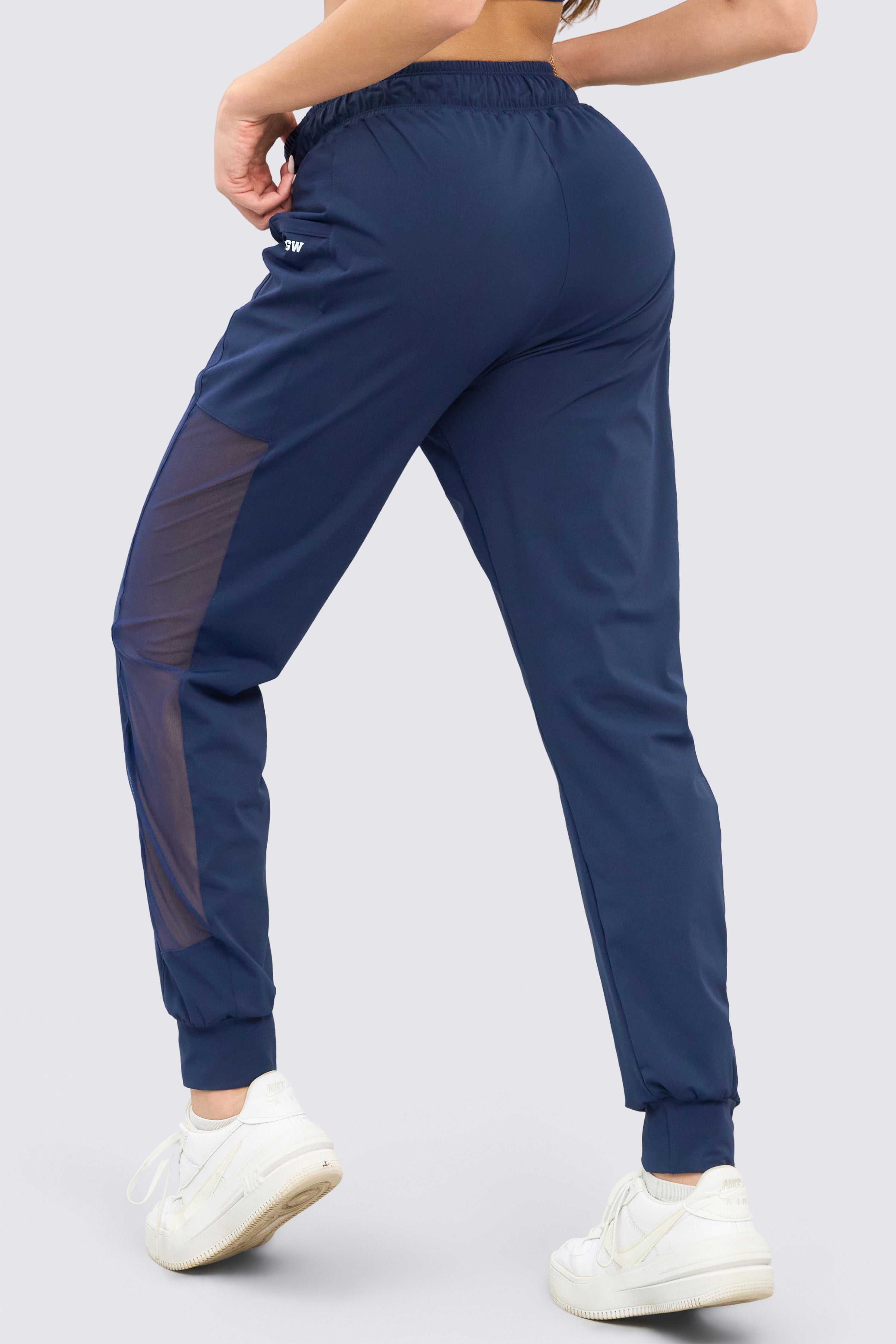Navy blue jogging pants with adjustable waistband and functional side pockets.
