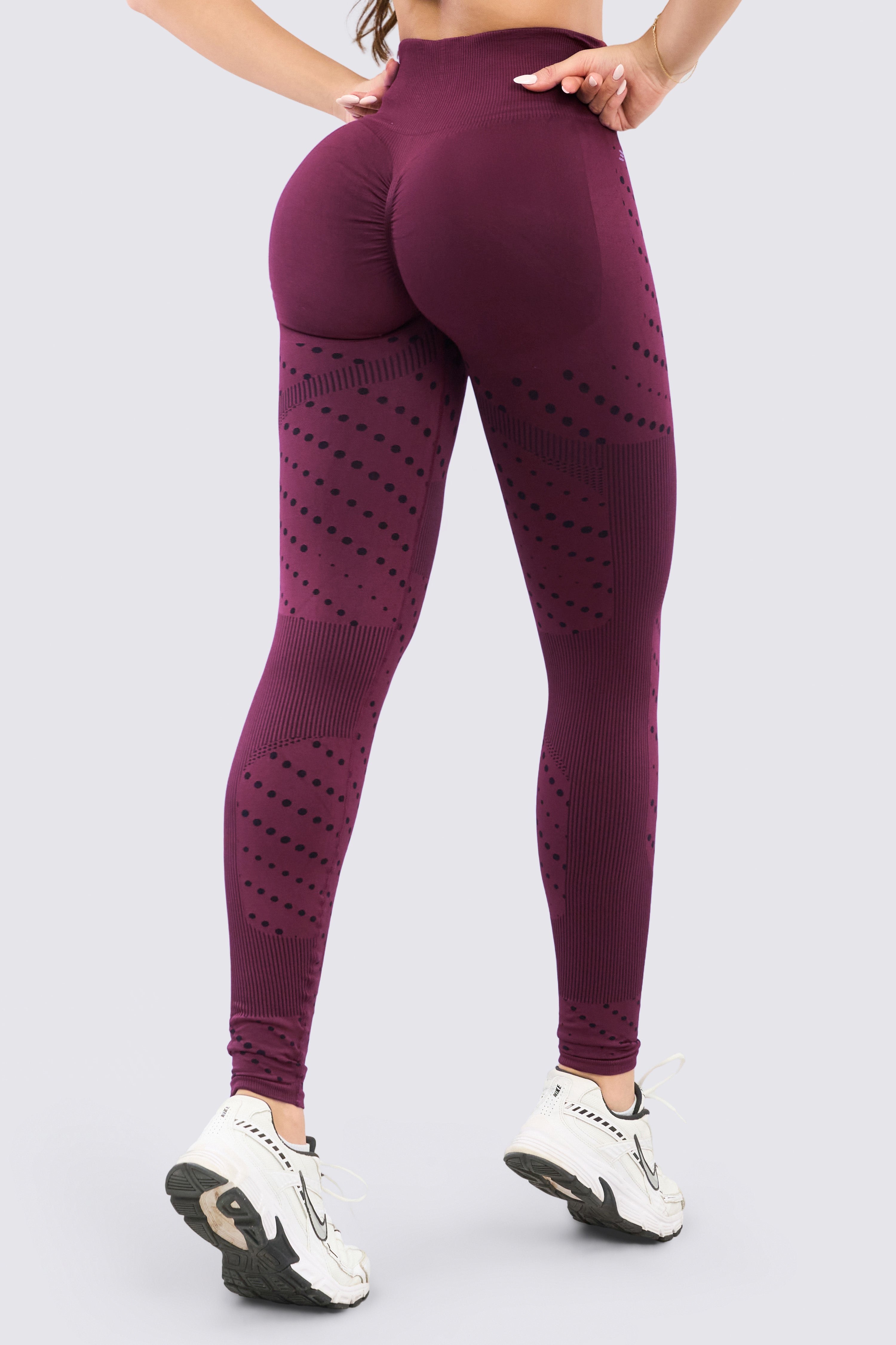 Seamless burgundy sports leggings with a high waistband and dot pattern designs.