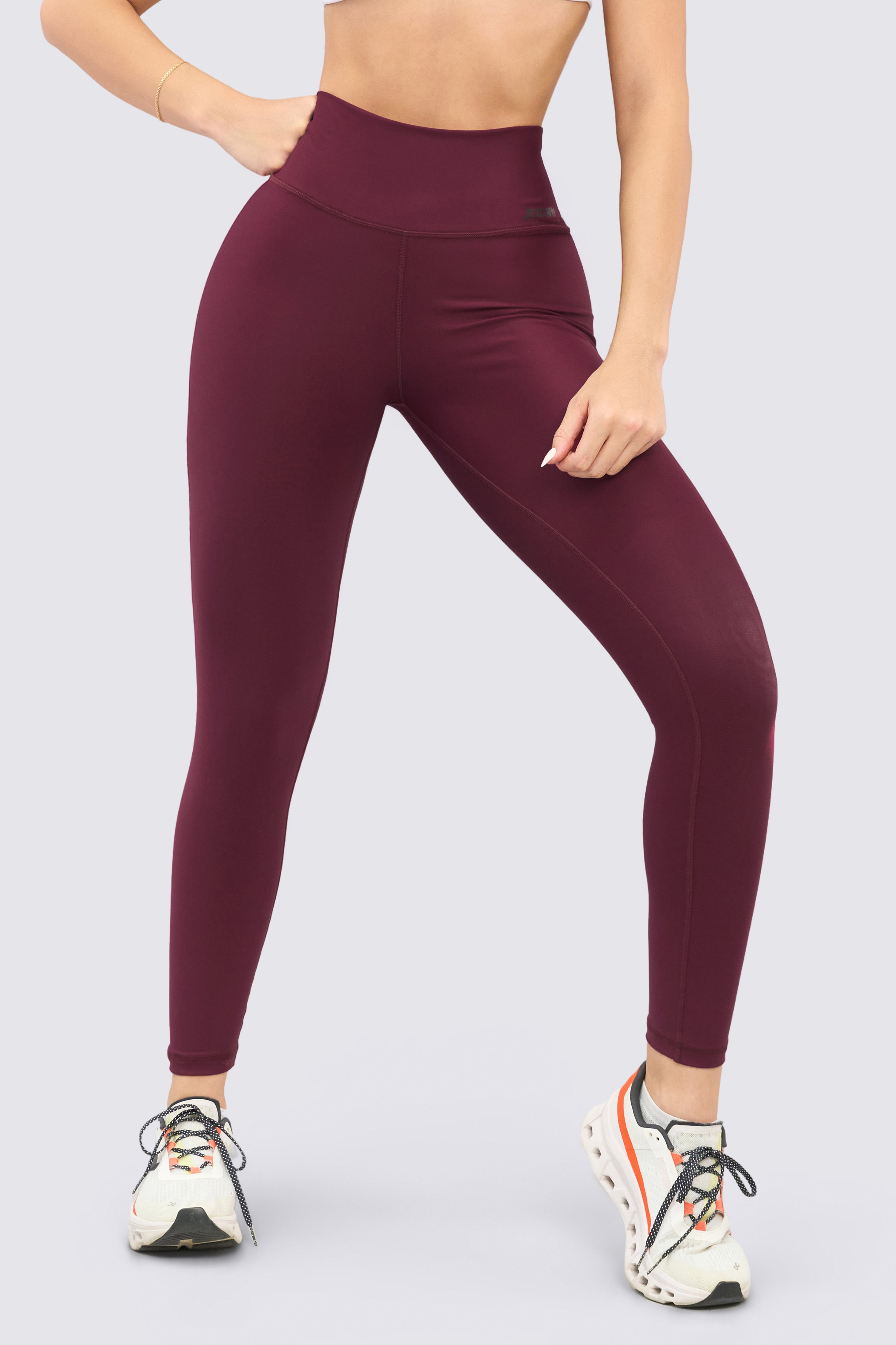 Burgundy sports leggings with a soft fit and high waistband, perfect for workouts.