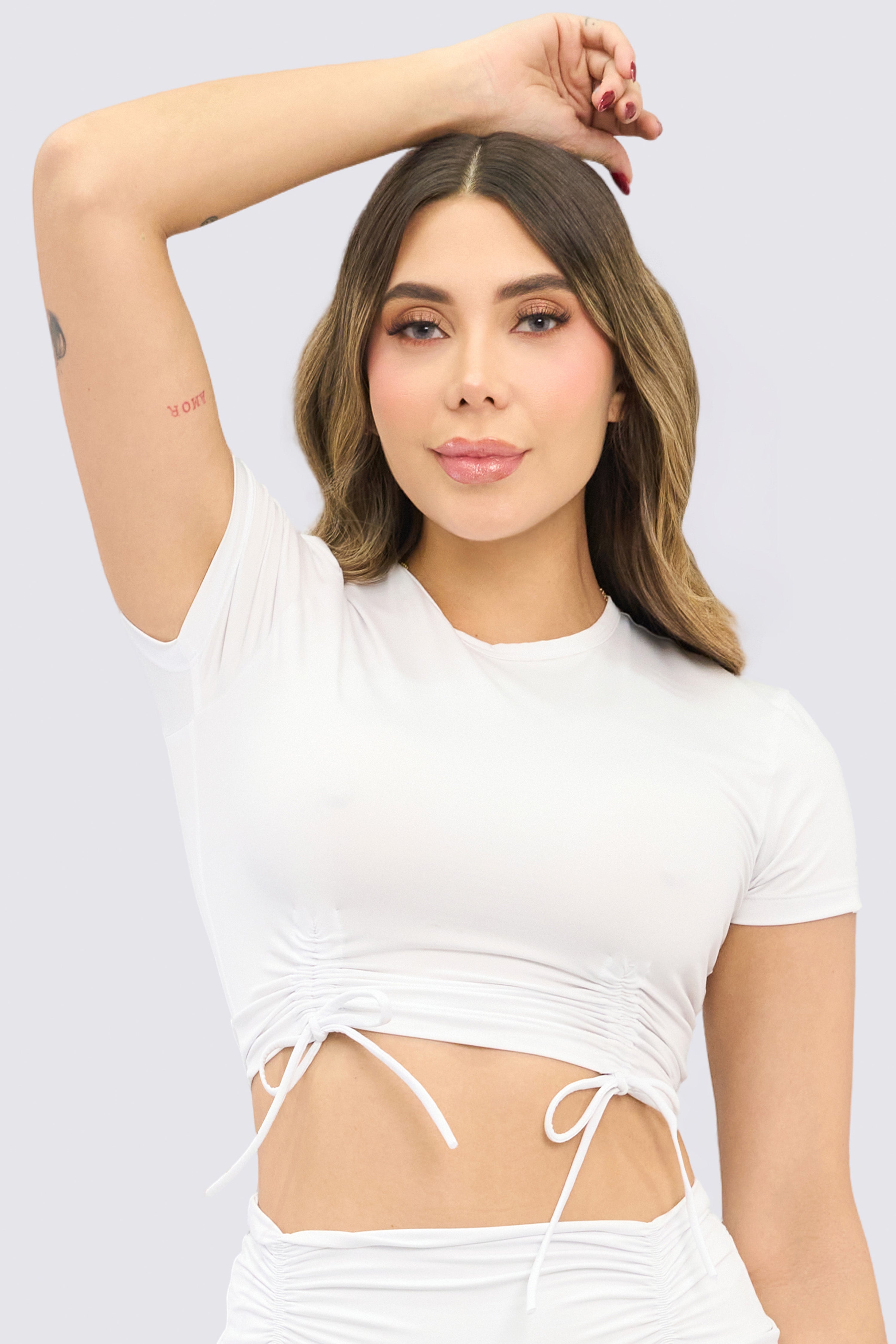 White sports crop top with adjustable straps.