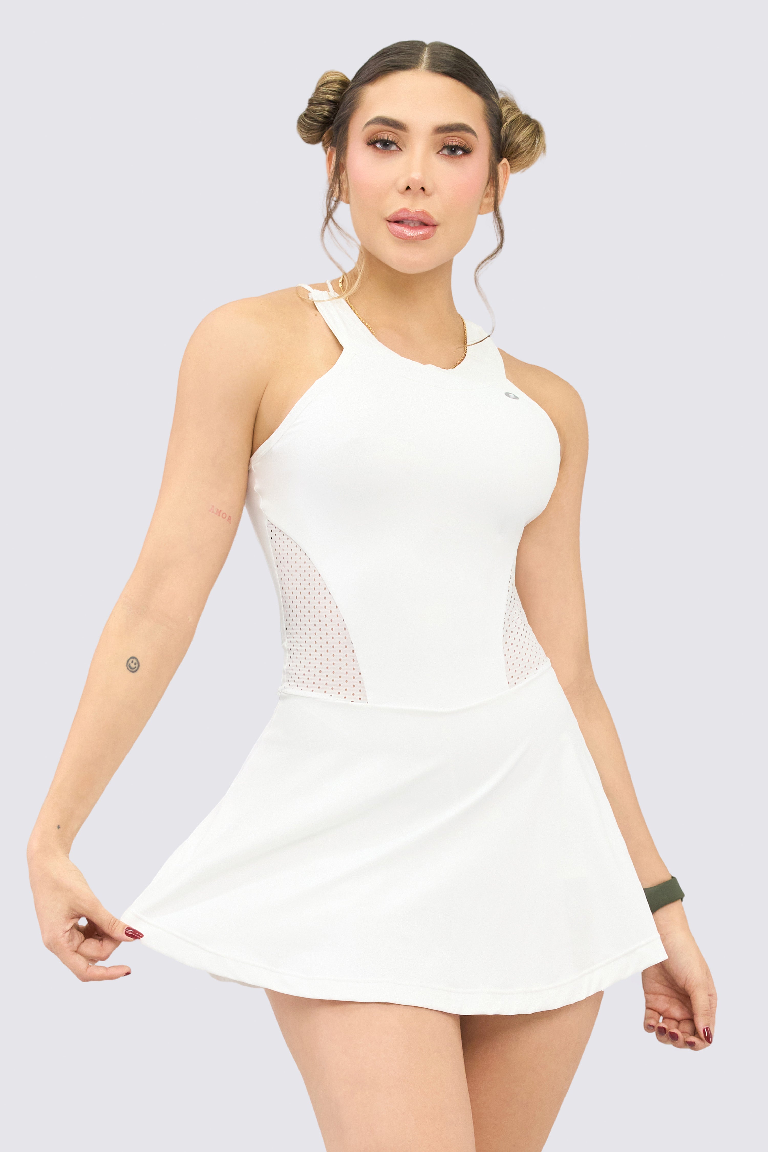 White sports dress with built-in shorts and crisscross straps at the back.